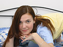 Beautiful young harlot starts a provocative masturbation play laying naked in bed